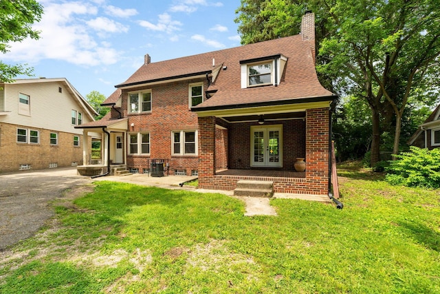 992 N Nelson Rd, Columbus, OH 43219 - view of front of home featuring french doors, a chimney, brick siding, a front yard, and a shingled roof