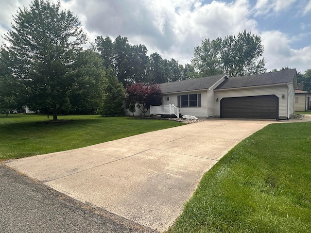 477 Greenlawn Dr, Howard, OH 43028 - view of front of home with an attached garage, a front lawn, and concrete driveway