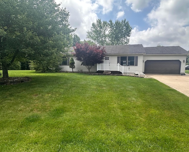 477 Greenlawn Dr, Howard, OH 43028 - view of front of home featuring an attached garage, driveway, and a front lawn