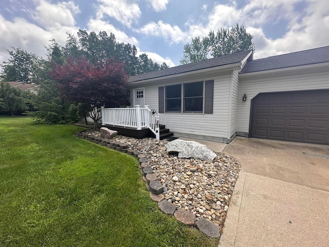 477 Greenlawn Dr, Howard, OH 43028 - view of front of house with a front yard, concrete driveway, an attached garage, and a deck