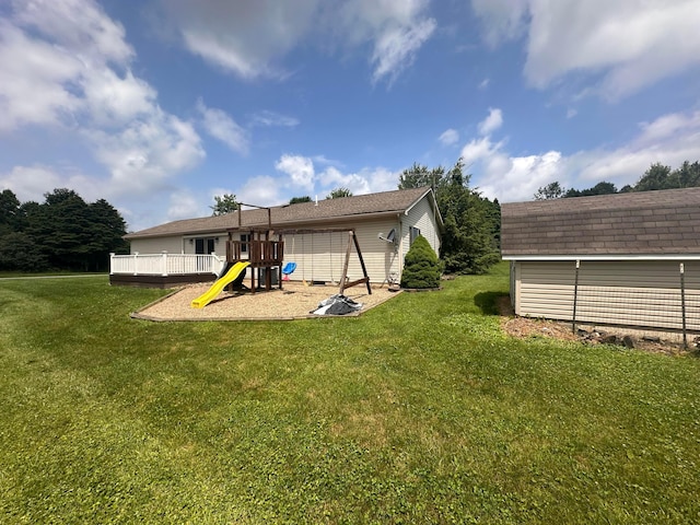 477 Greenlawn Dr, Howard, OH 43028 - back of house with a playground, a lawn, an outbuilding, and a wooden deck