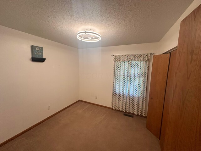 477 Greenlawn Dr, Howard, OH 43028 - carpeted spare room with baseboards and a textured ceiling