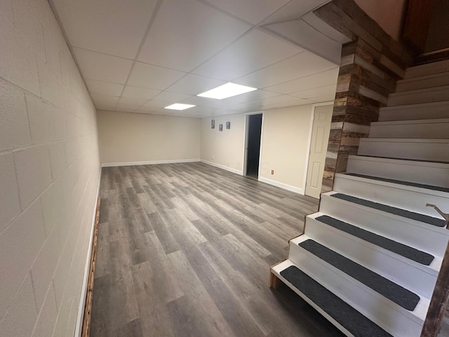 477 Greenlawn Dr, Howard, OH 43028 - finished basement with stairs, wood finished floors, concrete block wall, and a paneled ceiling