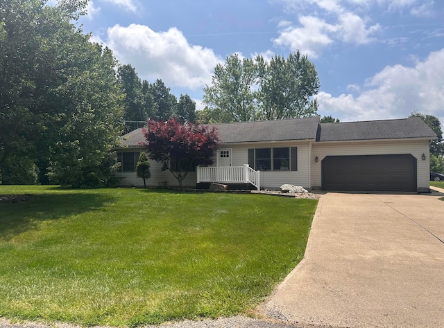 477 Greenlawn Dr, Howard, OH 43028 - ranch-style home featuring a garage, concrete driveway, and a front lawn