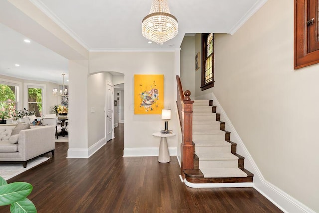 249 E Whittier St, Columbus, OH 43206 - foyer entrance featuring a chandelier, wood finished floors, arched walkways, stairway, and crown molding