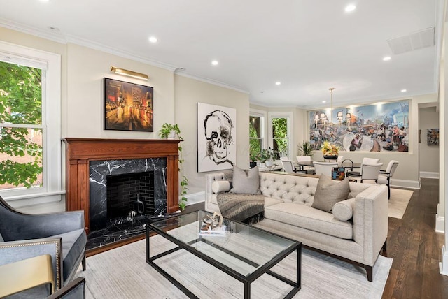 249 E Whittier St, Columbus, OH 43206 - living room featuring recessed lighting, wood finished floors, healthy amount of natural light, ornamental molding, and a high end fireplace