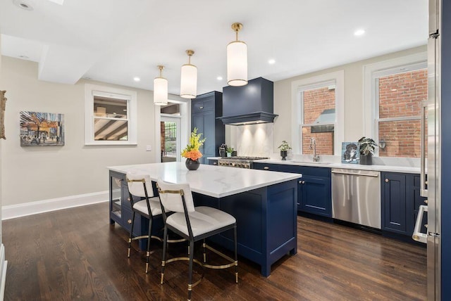 249 E Whittier St, Columbus, OH 43206 - kitchen featuring dishwasher, premium range hood, dark wood finished floors, blue cabinets, and a kitchen breakfast bar