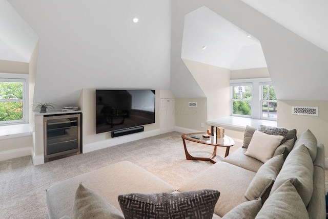 249 E Whittier St, Columbus, OH 43206 - carpeted living room with beverage cooler, healthy amount of natural light, and vaulted ceiling