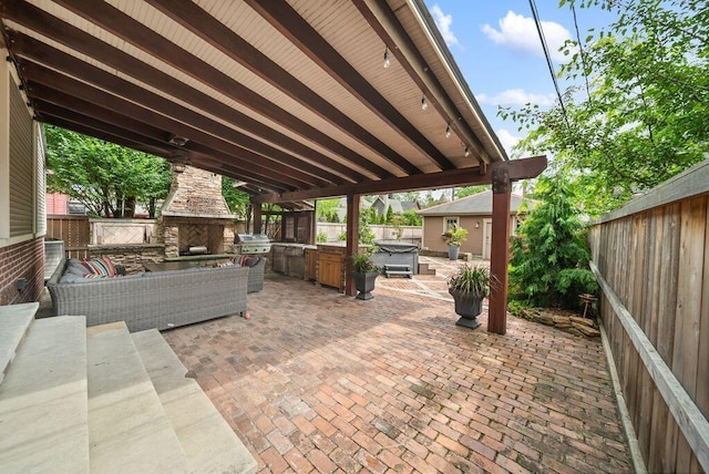 249 E Whittier St, Columbus, OH 43206 - fenced backyard with an outdoor stone fireplace, a patio area, and area for grilling