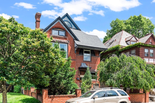 726 Franklin Ave, Columbus, OH 43205 - tudor home with brick siding, a chimney, and a shingled roof