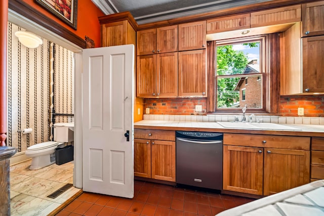 726 Franklin Ave, Columbus, OH 43205 - kitchen with stainless steel dishwasher, backsplash, and brown cabinets