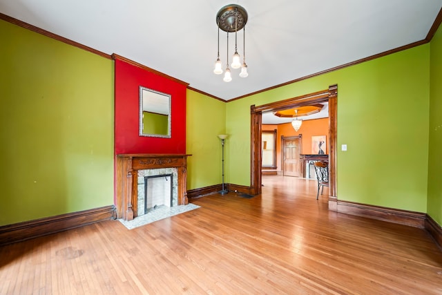 726 Franklin Ave, Columbus, OH 43205 - unfurnished living room with ornamental molding, wood finished floors, and a high end fireplace