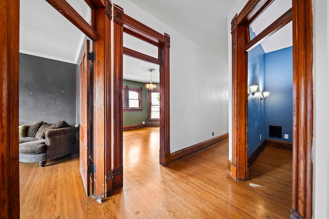 726 Franklin Ave, Columbus, OH 43205 - hall with light wood-style flooring and a chandelier