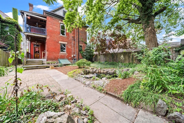 726 Franklin Ave, Columbus, OH 43205 - rear view of house with a balcony, brick siding, and a chimney