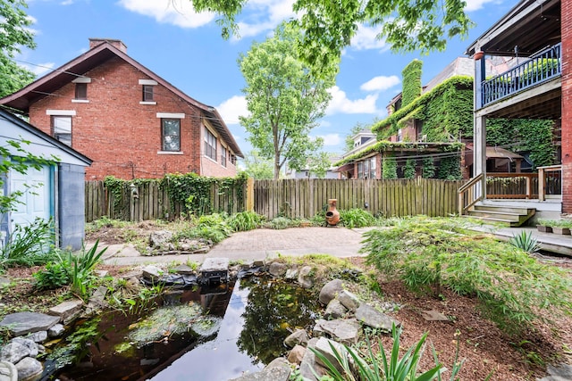 726 Franklin Ave, Columbus, OH 43205 - fenced backyard with a garden pond and an outdoor structure
