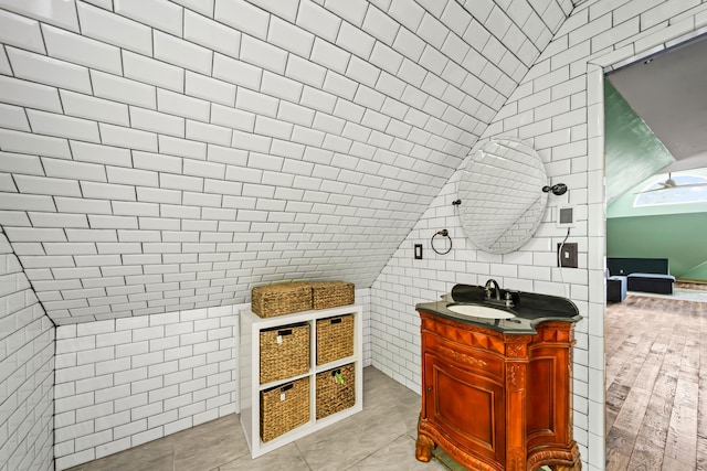 726 Franklin Ave, Columbus, OH 43205 - bathroom with vanity, tile walls, and lofted ceiling