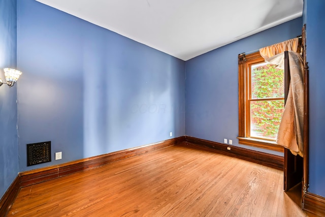 726 Franklin Ave, Columbus, OH 43205 - spare room featuring wood finished floors and a chandelier