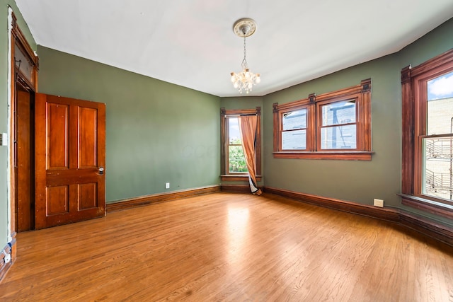 726 Franklin Ave, Columbus, OH 43205 - empty room featuring a chandelier, healthy amount of natural light, and wood finished floors