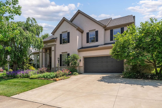 5650 Tynecastle Loop, Dublin, OH 43016 - traditional home with a garage, stucco siding, driveway, a front lawn, and stone siding
