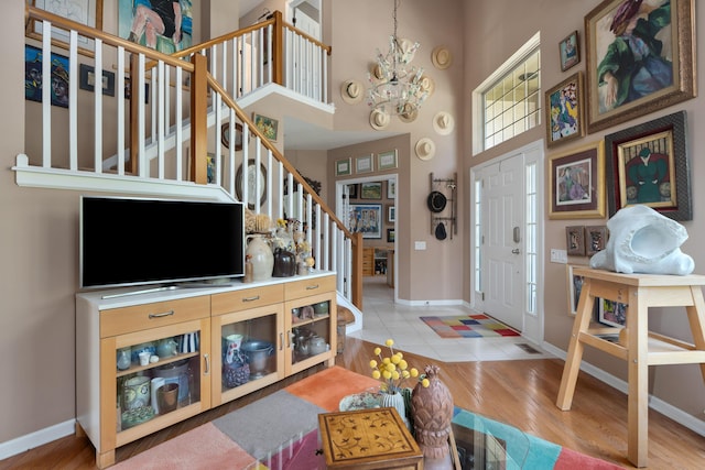 5650 Tynecastle Loop, Dublin, OH 43016 - entrance foyer featuring stairway, a chandelier, a towering ceiling, and wood finished floors
