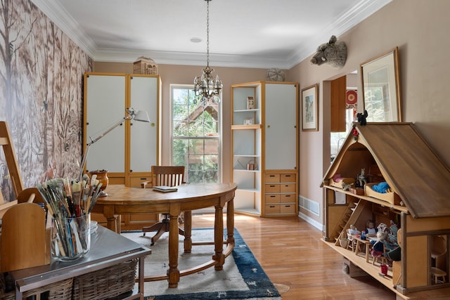5650 Tynecastle Loop, Dublin, OH 43016 - dining room featuring light wood-type flooring, a chandelier, and crown molding