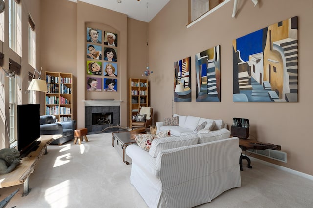 5650 Tynecastle Loop, Dublin, OH 43016 - living room featuring a towering ceiling, carpet floors, and a tile fireplace