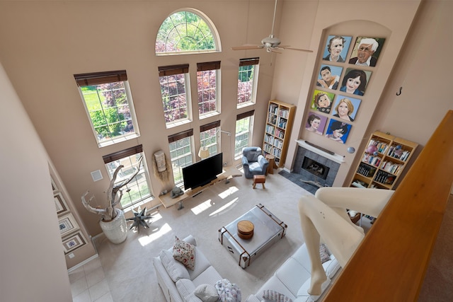 5650 Tynecastle Loop, Dublin, OH 43016 - living room featuring a high ceiling, a fireplace, carpet floors, and a ceiling fan