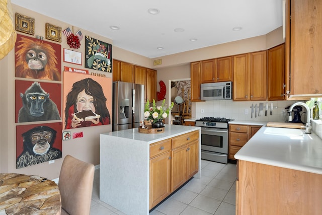 5650 Tynecastle Loop, Dublin, OH 43016 - kitchen with stainless steel appliances, light countertops, a center island, decorative backsplash, and light tile patterned floors