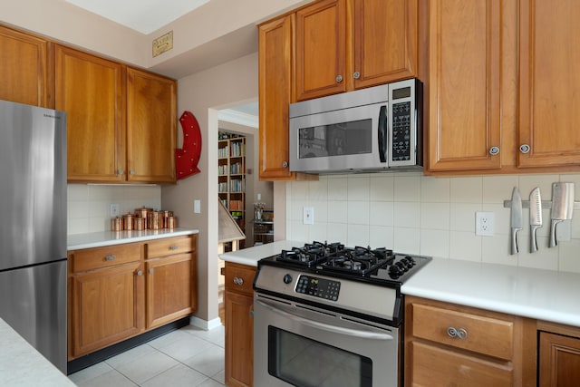 5650 Tynecastle Loop, Dublin, OH 43016 - kitchen featuring stainless steel appliances, light countertops, and backsplash