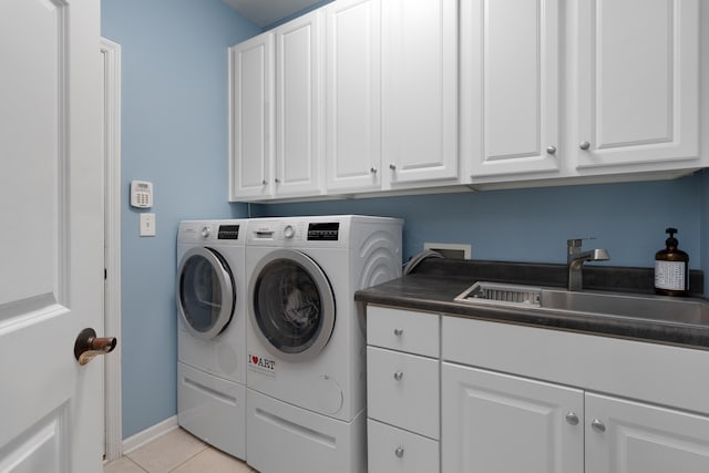 5650 Tynecastle Loop, Dublin, OH 43016 - laundry area with cabinet space, washing machine and dryer, and light tile patterned floors
