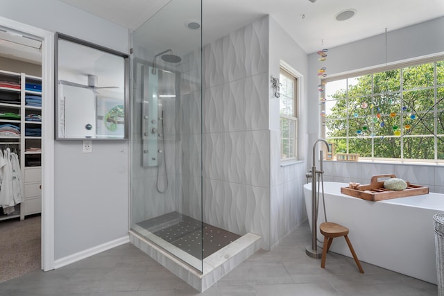 5650 Tynecastle Loop, Dublin, OH 43016 - full bath featuring a stall shower, a soaking tub, a spacious closet, and a ceiling fan