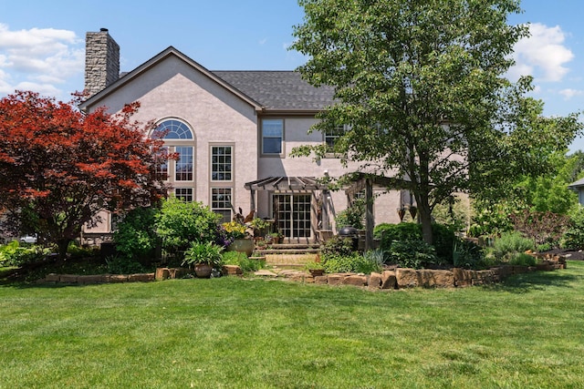5650 Tynecastle Loop, Dublin, OH 43016 - back of property with a lawn, a chimney, stucco siding, and a shingled roof