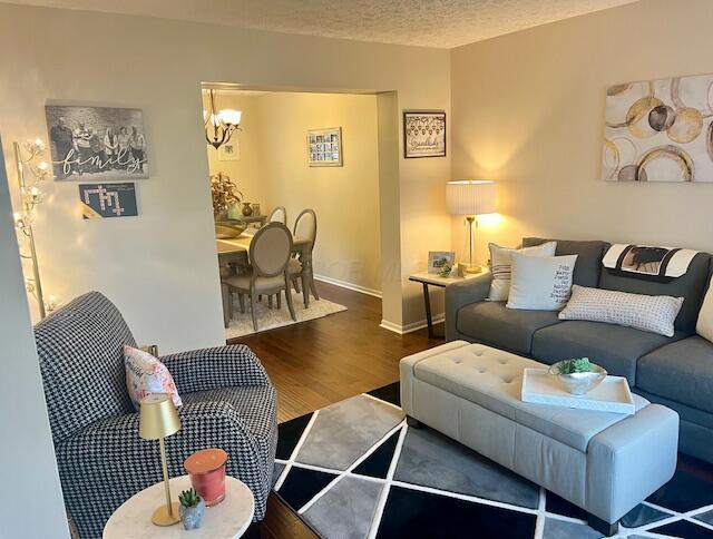 1768 Fern Trail Dr, Lancaster, OH 43130 - living area featuring wood finished floors and a chandelier