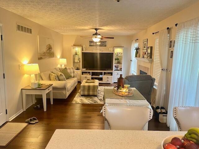 1768 Fern Trail Dr, Lancaster, OH 43130 - living room with ceiling fan, a textured ceiling, hardwood / wood-style floors, and a fireplace