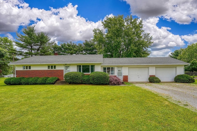 3180 Sitterley Rd NW, Canal Winchester, OH 43110 - ranch-style house featuring driveway, a garage, a front yard, brick siding, and a chimney