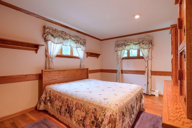 3180 Sitterley Rd NW, Canal Winchester, OH 43110 - bedroom with baseboard heating, multiple windows, crown molding, wood finished floors, and recessed lighting