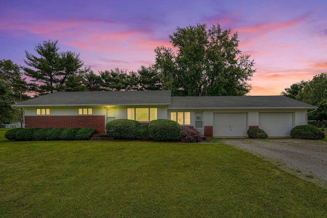 3180 Sitterley Rd NW, Canal Winchester, OH 43110 - ranch-style home featuring gravel driveway, an attached garage, a front lawn, and brick siding