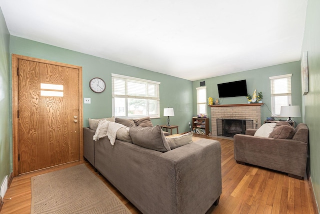 335 Letchworth Ave, Columbus, OH 43204 - living area with healthy amount of natural light, light wood finished floors, and a brick fireplace