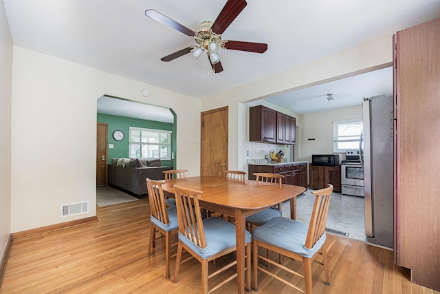 335 Letchworth Ave, Columbus, OH 43204 - dining room with light wood-style floors, arched walkways, and ceiling fan