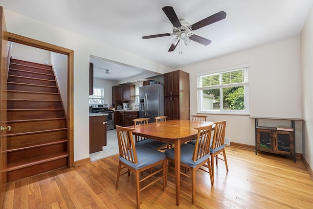 335 Letchworth Ave, Columbus, OH 43204 - dining room with plenty of natural light, light wood-type flooring, stairway, and ceiling fan