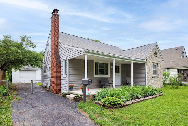 335 Letchworth Ave, Columbus, OH 43204 - view of front facade featuring a shingled roof, an outbuilding, a chimney, and stone siding
