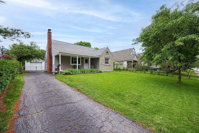 335 Letchworth Ave, Columbus, OH 43204 - ranch-style home featuring a chimney, a garage, stone siding, a porch, and an outdoor structure