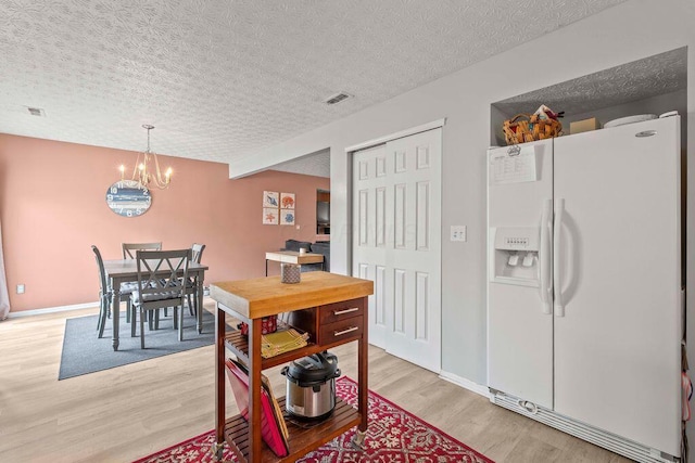 7780 Freesia St Unit 228, Blacklick, OH 43004 - dining space with light wood-style floors and a chandelier