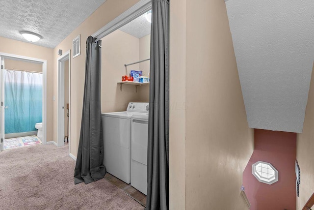 7780 Freesia St Unit 228, Blacklick, OH 43004 - laundry area featuring a textured ceiling, washing machine and clothes dryer, and carpet floors