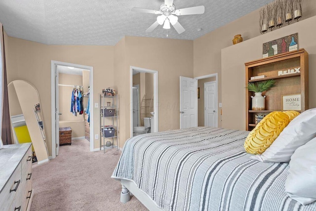 7780 Freesia St Unit 228, Blacklick, OH 43004 - bedroom with a closet, a walk in closet, light colored carpet, lofted ceiling, and a textured ceiling