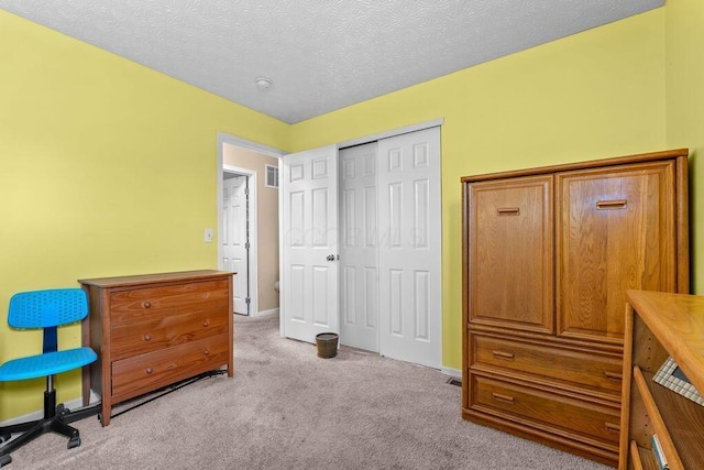 7780 Freesia St Unit 228, Blacklick, OH 43004 - carpeted bedroom featuring a closet and a textured ceiling