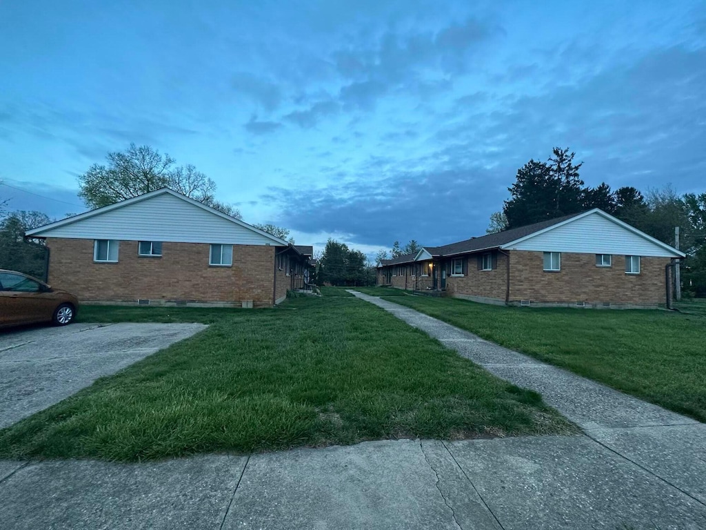 488 N Jay St, West Milton, OH 45383 - view of property exterior with brick siding and a yard