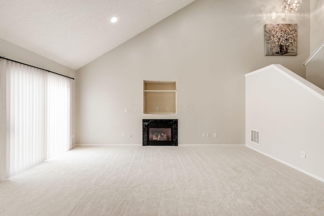5595 Marshfield Dr, Westerville, OH 43081 - unfurnished living room with a fireplace, carpet floors, high vaulted ceiling, a chandelier, and recessed lighting