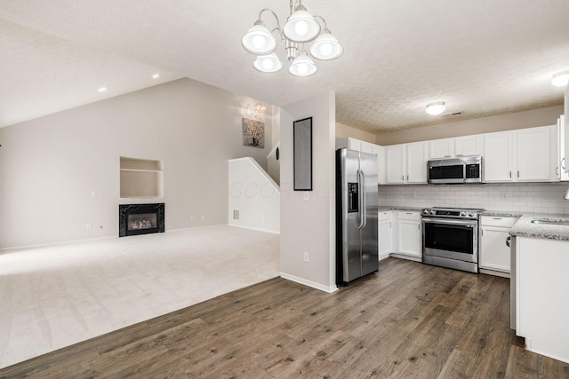 5595 Marshfield Dr, Westerville, OH 43081 - kitchen with stainless steel appliances, open floor plan, dark wood-style flooring, white cabinets, and a chandelier