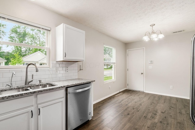 5595 Marshfield Dr, Westerville, OH 43081 - kitchen with dishwasher, dark wood-style flooring, tasteful backsplash, white cabinets, and healthy amount of natural light